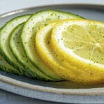 الليمون والخيار: ثنائي طبيعي للوقاية من السكري وحماية القلب من الجلطات 9 fresh sliced cucumber and lemon on plate a refreshing still life composition featuring vibrant colors natural light and a clean aesthetic perfect for health wellness food and diet related photo