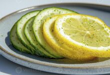 fresh sliced cucumber and lemon on plate a refreshing still life composition featuring vibrant colors natural light and a clean aesthetic perfect for health wellness food and diet related photo