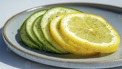 fresh sliced cucumber and lemon on plate a refreshing still life composition featuring vibrant colors natural light and a clean aesthetic perfect for health wellness food and diet related photo