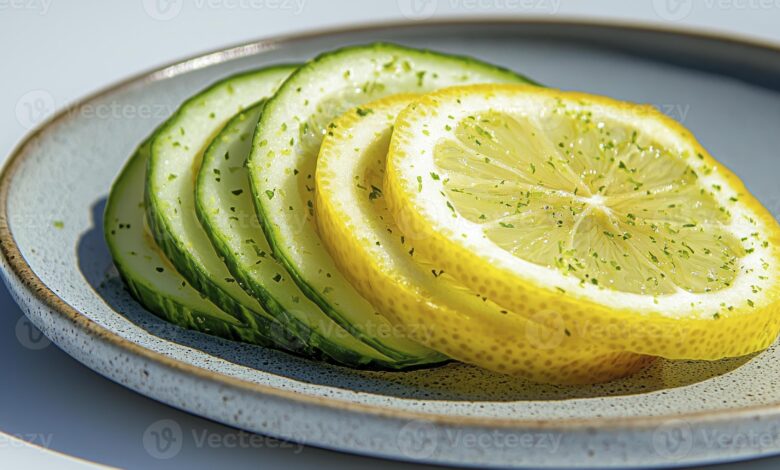fresh sliced cucumber and lemon on plate a refreshing still life composition featuring vibrant colors natural light and a clean aesthetic perfect for health wellness food and diet related photo